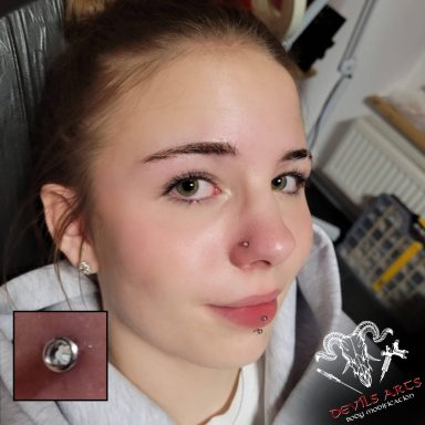 Nostril-Piercing mit silbernem Nasenstecker und Kristall.
